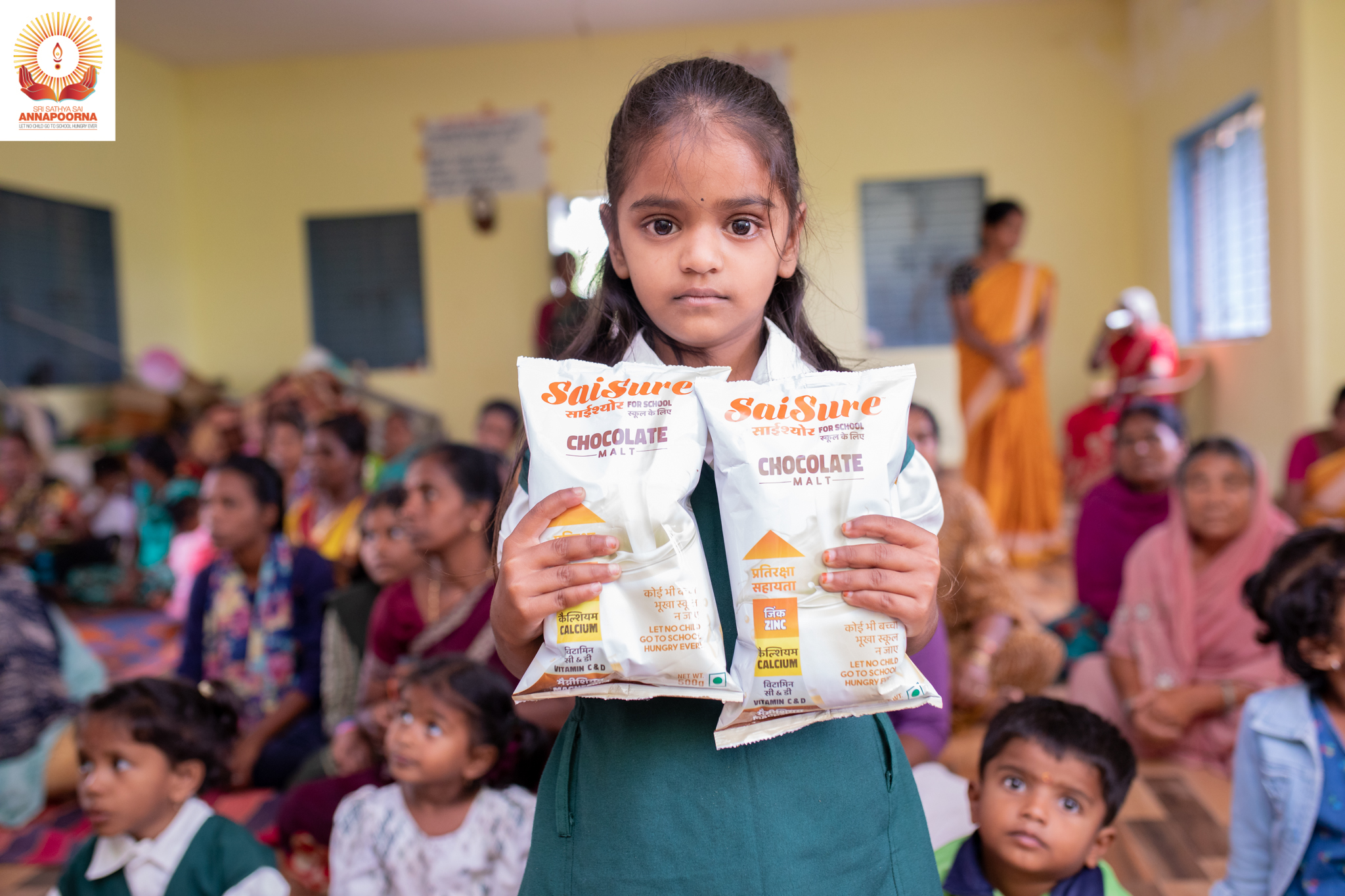 Student holding SaiSure nutrition packets