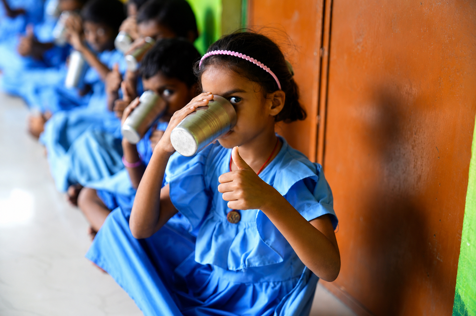 Girl with thumbs up drinking morning nutrition milk